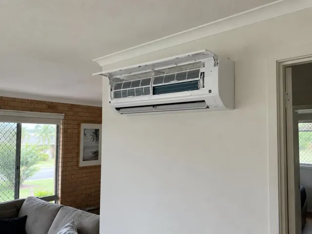 Open split-system indoor unit with clean filters on a living room wall in a home in Robina