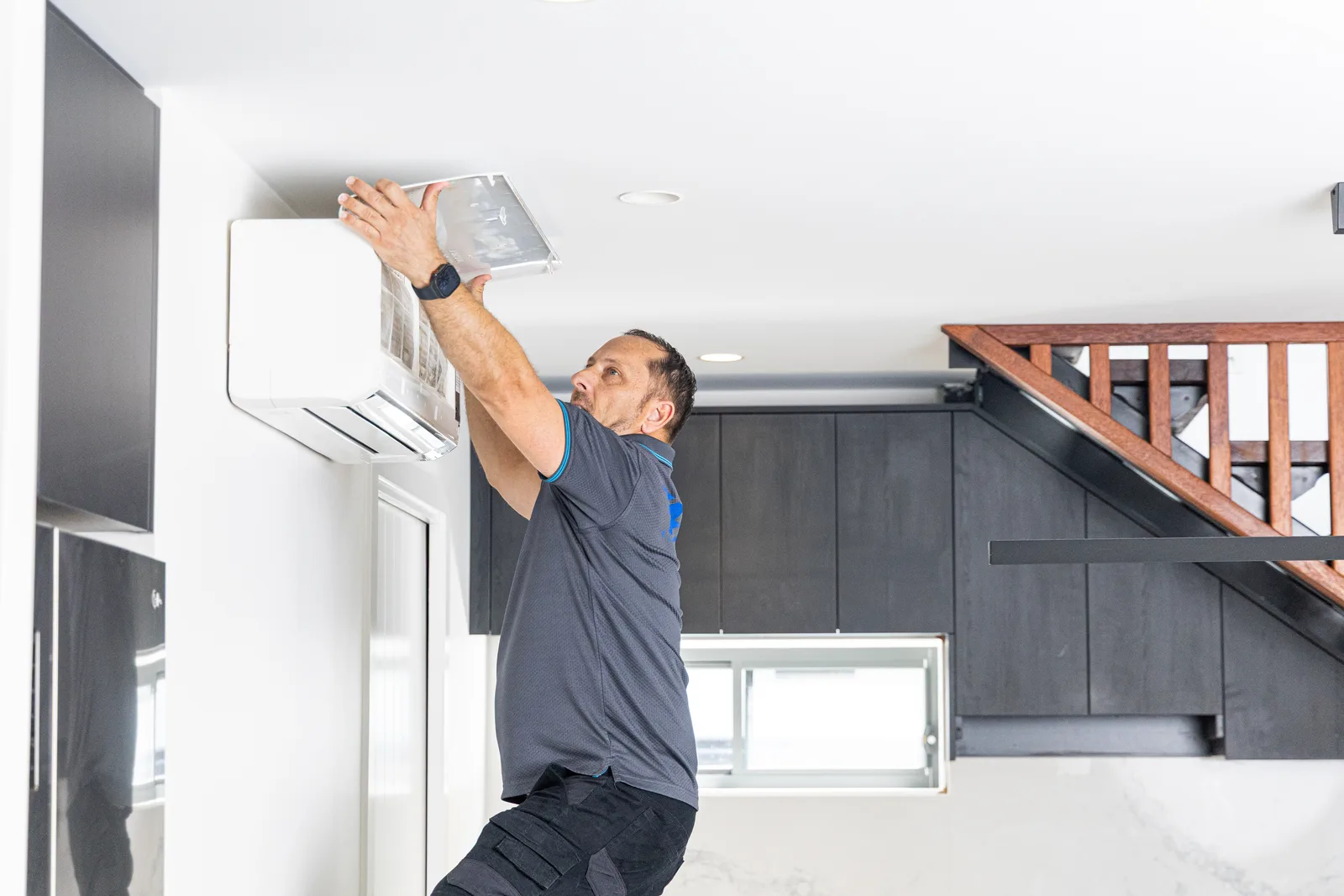 Technician installing a split system air conditioner